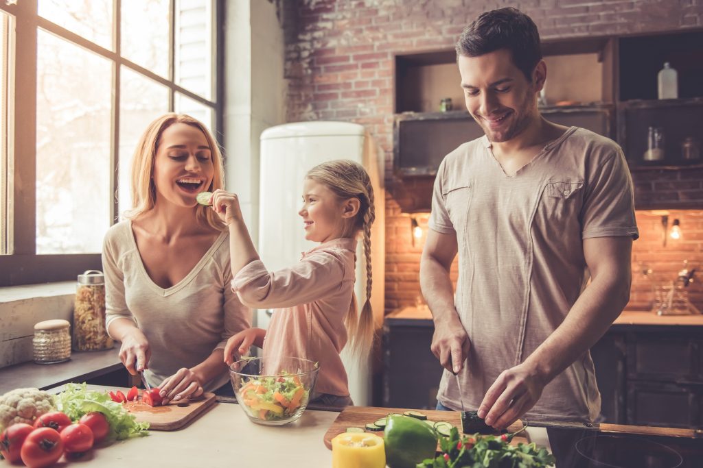 Happy family in kitchen knowing Home Security Basics